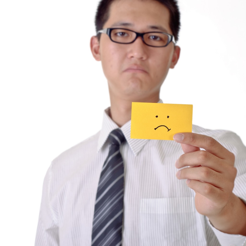 Asian professional man just received bad news. Are you stuck? i can help.